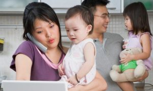 Family in kitchen with laptop