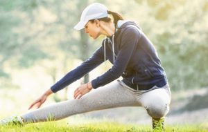 Female fitness model training outside in Park