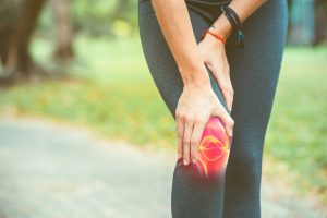 Woman,Holding,Her,Knee,With,Red,Pain,On,The,Skeleton